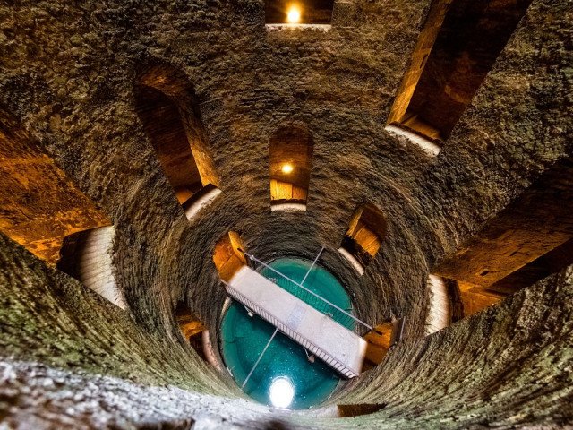 Interior of the Well of San Patrizio, seen from above, detail of the walkway that crosses the water and then climbs up the other flight of stairs, 2022