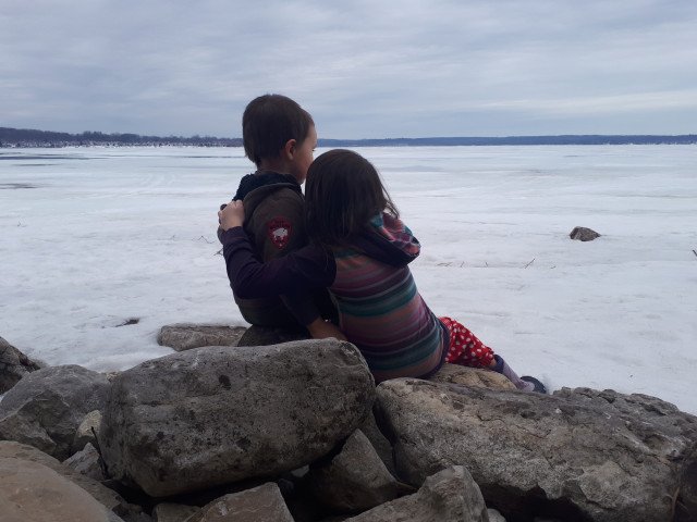 Two children looking across a frozen Georgian Bay from the Port McNicoll side